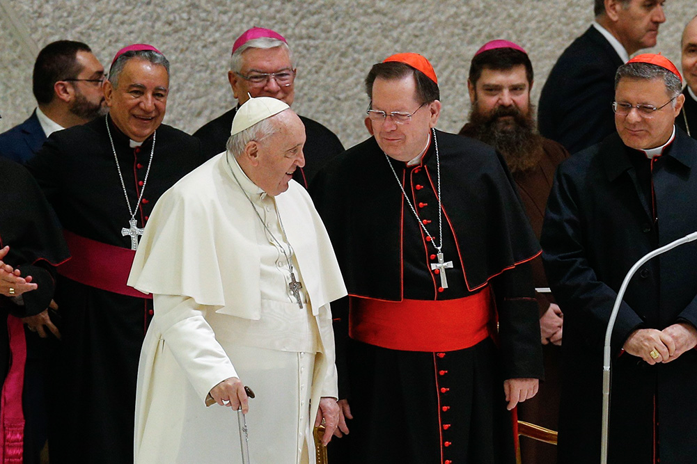 Pope Francis greets Cardinal Gérald Lacroix of Quebec as he arrives to lead his general audience in the Paul VI hall at the Vatican Jan. 4, 2023. (CNS/Paul Haring)