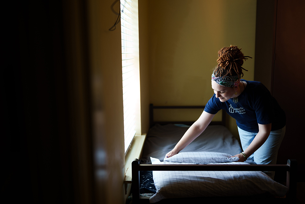 A case worker with Catholic Charities of Acadiana is pictured in a file photo preparing a bed at St. Joseph Shelter, an emergency shelter that cares for 87 individuals experiencing homelessness in and around Lafayette, Louisiana. (OSV News/Courtesy of Catholic Charities of Acadiana/Jason Cohen)