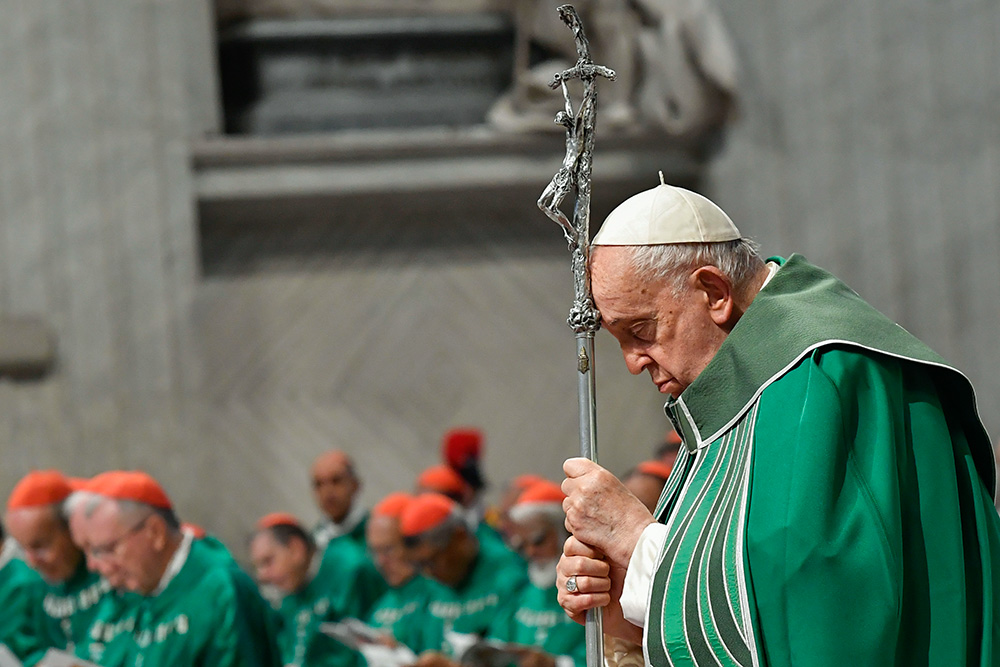 Pope Francis prays while holding a crosier during Mass in St. Peter's Basilica at the Vatican Oct. 29, 2023, marking the conclusion of the first session of the Synod of Bishops on synodality. The second session of the Synod on Synodality takes place at the Vatican Oct. 2-27, 2024. (CNS/Vatican Media)