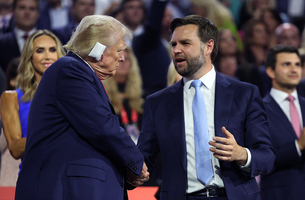 Republican presidential nominee and former President Donald Trump and Republican vice presidential nominee J.D. Vance interact during the Republican National Convention in Milwaukee July 15. Trump was shot in the ear July 13 in an assassination attempt during a campaign rally in Butler, Pennsylvania, that also claimed the life of at least one spectator and critically injured two others before the shooter was shot dead by the Secret Service. (OSV News/Reuters/Andrew Kelly)