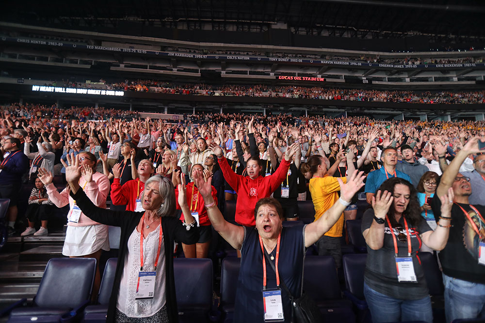 Pilgrims sing along with Catholic musician Matt Maher during the July 20 revival night of the National Eucharistic Congress at Lucas Oil Stadium in Indianapolis. (OSV News/Bob Roller)