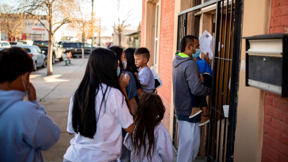 A migrant family is dropped off Dec. 13, 2022, at a local migrant shelter run by the Annunciation House in downtown El Paso, Texas. 
