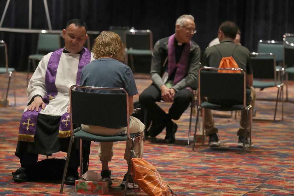 Priests hear confessions at eucharistic conference. 