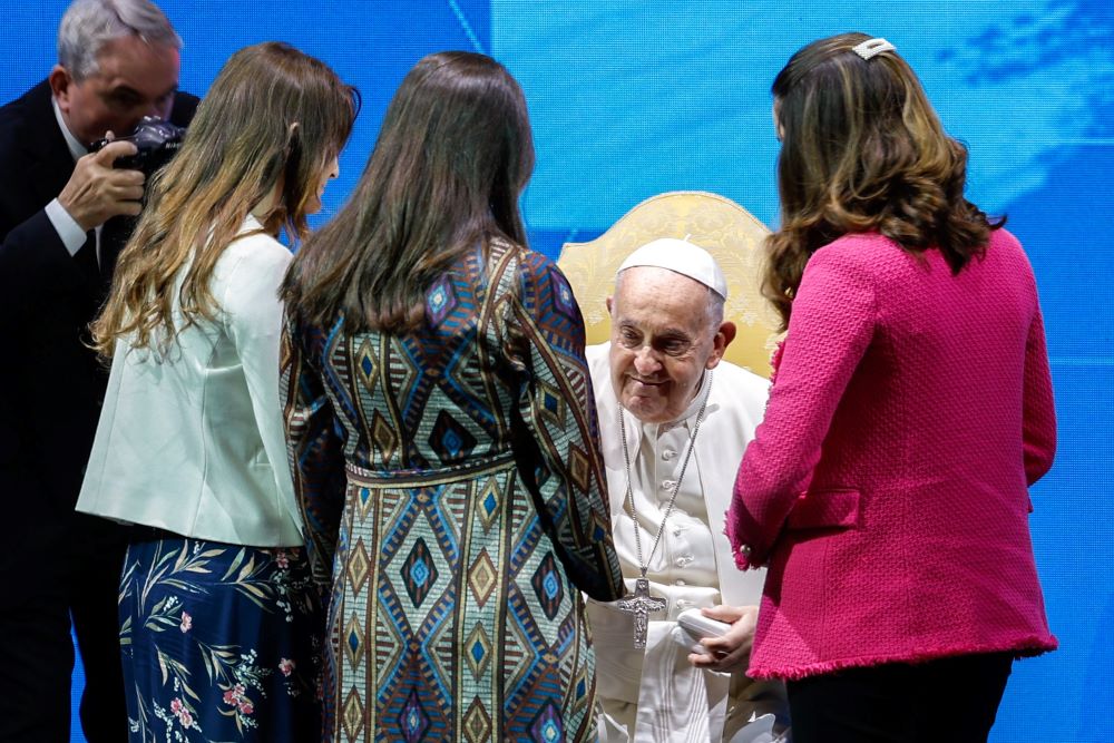 Pope Francis blesses three pregnant women at an annual meeting on Italy's declining birthrate at an auditorium in Rome May 10. (CNS/Lola Gomez)