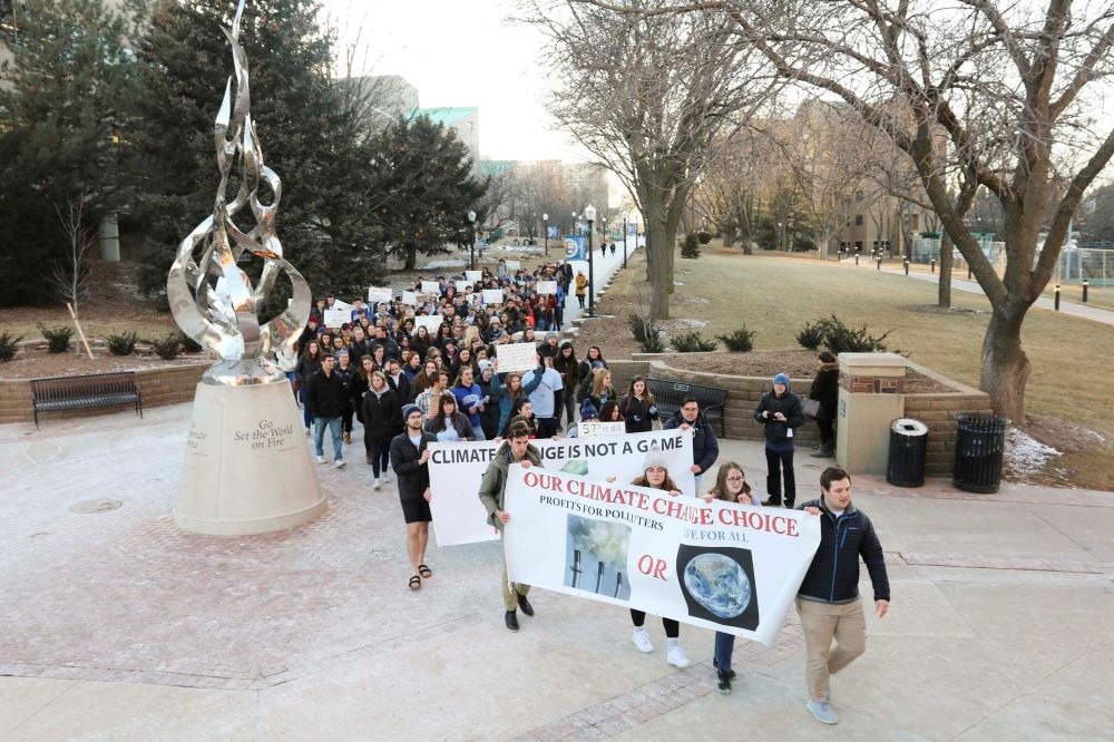People rally at Creighton University in Omaha, Nebraska, Feb. 20, 2020, calling for the Jesuit-run school to fully divest from fossil fuels. 