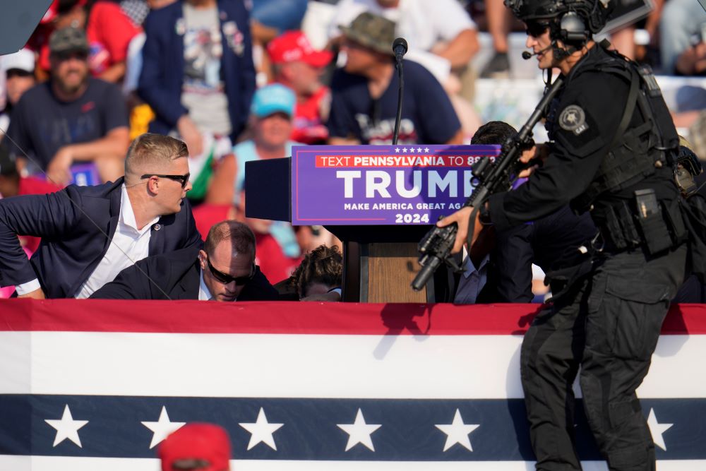 Republican presidential candidate former President Donald Trump is surrounded by U.S. Secret Service after an assassination attempt at a campaign event in Butler, Pennsylvania, on July 13. 