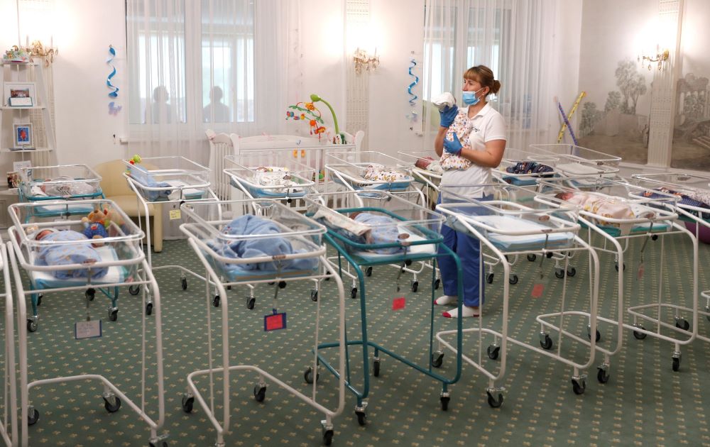 A nurse and newborns are seen in the Hotel Venice in Kyiv, Ukraine, May 14, 2020. The hotel is owned by BioTexCom, a surrogacy agency. 