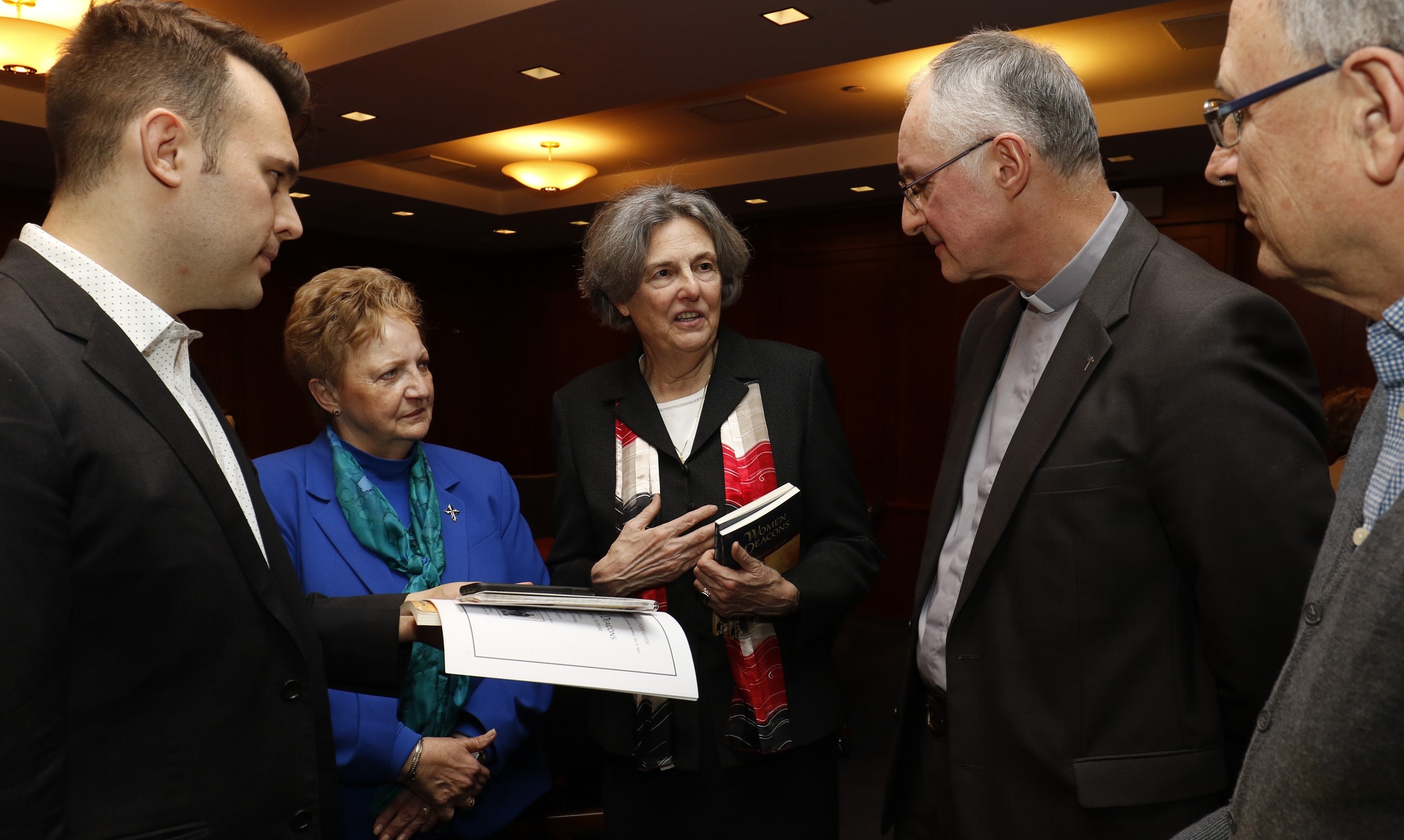 Catholic scholar and author Phyllis Zagano is flanked by Dominican Sr. Donna Ciangio and Jesuit Fr. Bernard Pottier as she speaks with journalists prior to a Jan. 15, 2019, symposium on the history and future of women deacons in the Catholic Church. (CNS/Gregory A. Shemitz) 