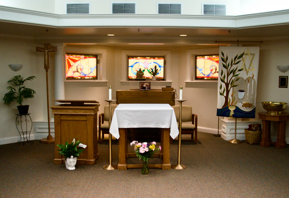 The ecumenical chapel at Paul's Run Retirement Community has one tabernacle for the holy Eucharist, another for the Torah, and a basket of Muslim prayer rugs. (GSR photo/Dan Stockman)