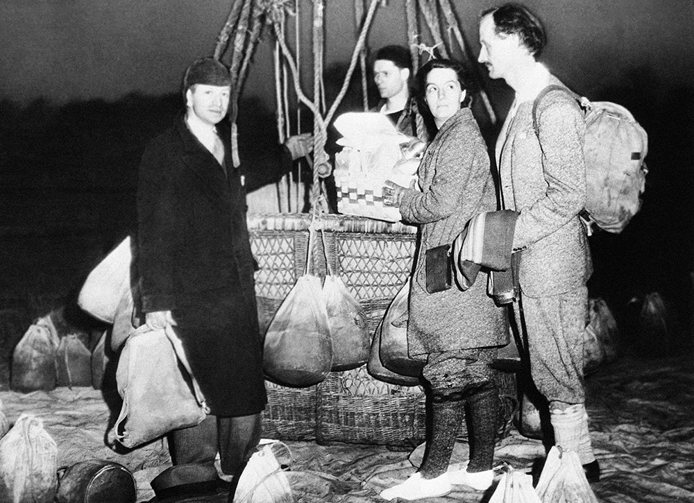 Jeannette Piccard, then training for a flight into the stratosphere with her husband, Professor Jean Piccard, is shown with her husband, at right, and Edward J. Hill, left, well known balloonist, just before they took off on a training flight at Detroit, on May 16, 1934. (AP photo)