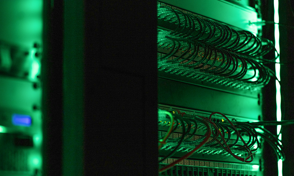 Close-up of a data server in green light (Unsplash/Tyler)