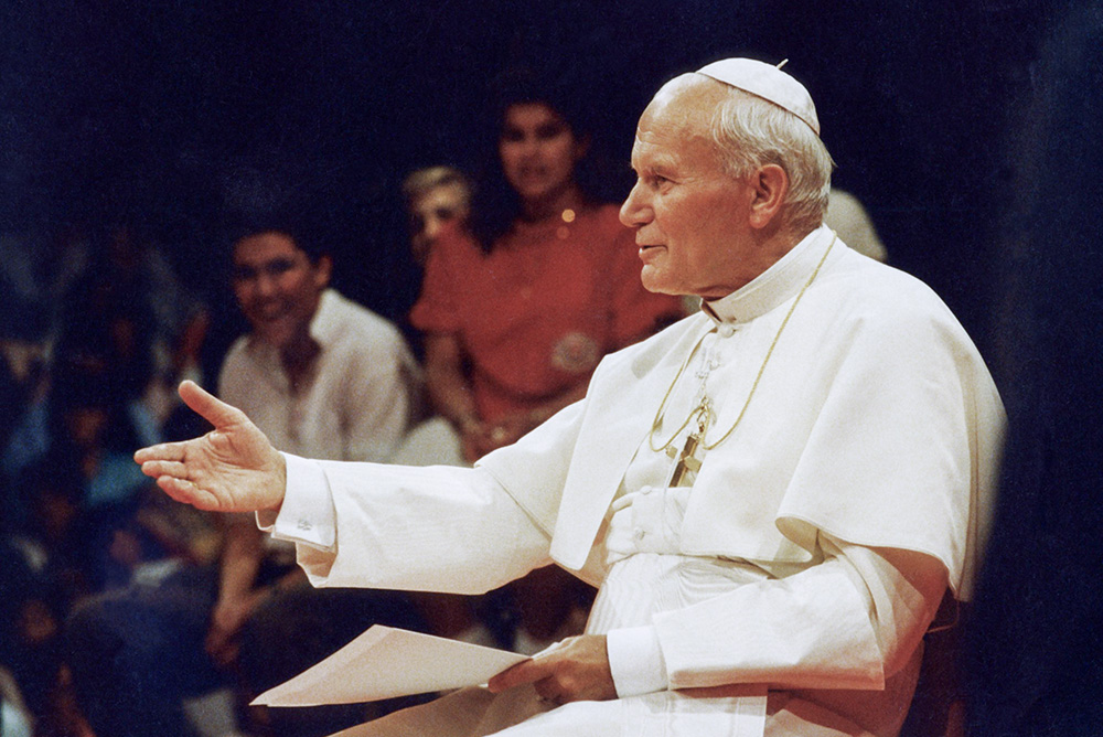 Pope John Paul II answers questions from young people in Los Angeles Sept. 15, 1987, during a teleconference broadcast to several locations in the United States. (CNS/Joe Rimkus Jr.)