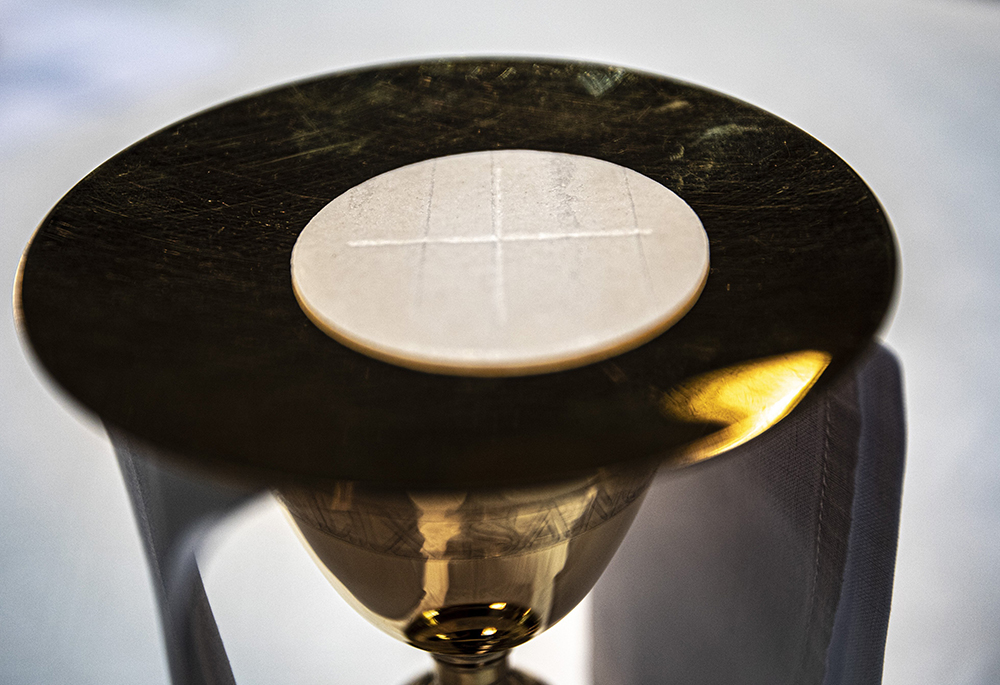 The Eucharist rests on a paten at the altar in the Cathedral of St. Peter in Wilmington, Delaware, on May 27, 2021. (CNS/Chaz Muth)