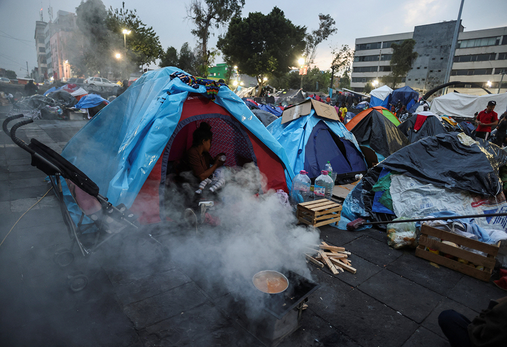 Migrants, mostly from Venezuela and Haiti, gather outside Our Lady of the Solitude Church in Mexico City at a makeshift tent city camp Nov. 27, 2023, as they wait for an appointment to be set up with U.S. Customs and Border Protection through the agency's CBP One smartphone app. (OSV News/Reuters/Gustavo Graf)