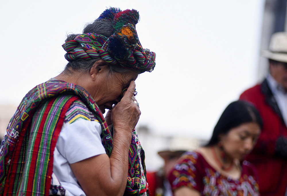 Ana de Leon, from the Maya Ixil people and a survivor of the internal armed conflict, reacts while participating with others in a ritual, outside the Supreme Court and prior to a hearing in the Maya Ixil genocide trial, March 25 in Guatemala City, Guatemala. (OSV News/Reuters/Cristina Chiquin)