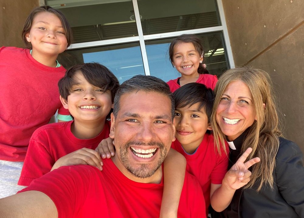 Father Anne (Anne Tropeano), right, poses with Javier Benavidez and his family. 