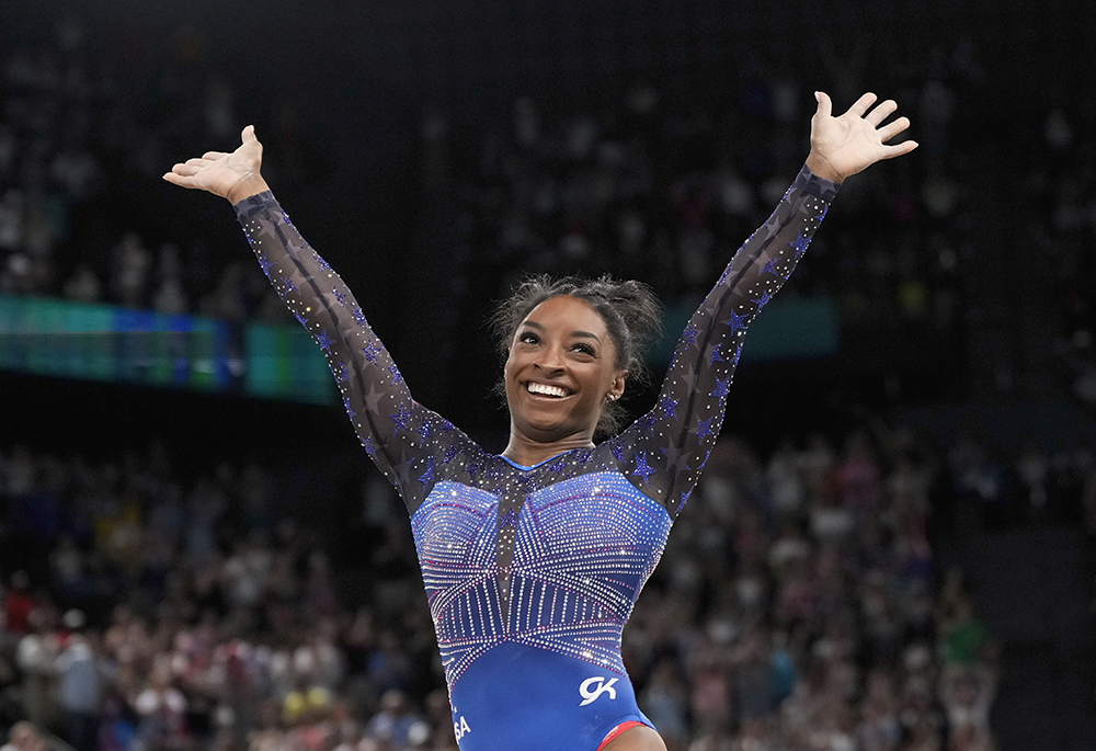 Simone Biles, of the United States, celebrates after performing in the floor exercise during the women's artistic gymnastics all-around finals in Bercy Arena at the 2024 Summer Olympics, Aug. 1 in Paris, France. (AP photo/Charlie Riedel)
