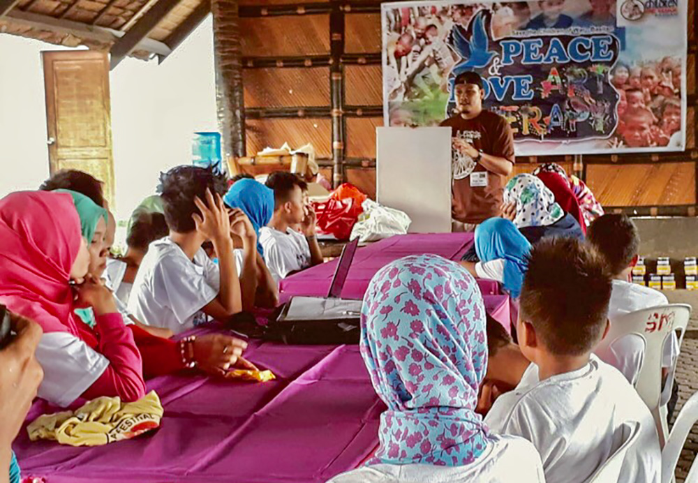 Franciscan Br. Christopher Villanueva leads an art therapy workshop with Muslim children whose fathers were members of Abu Sayyaf and died in the fighting in Basilan, the Philippines. (Courtesy of Order of Friars Minor)