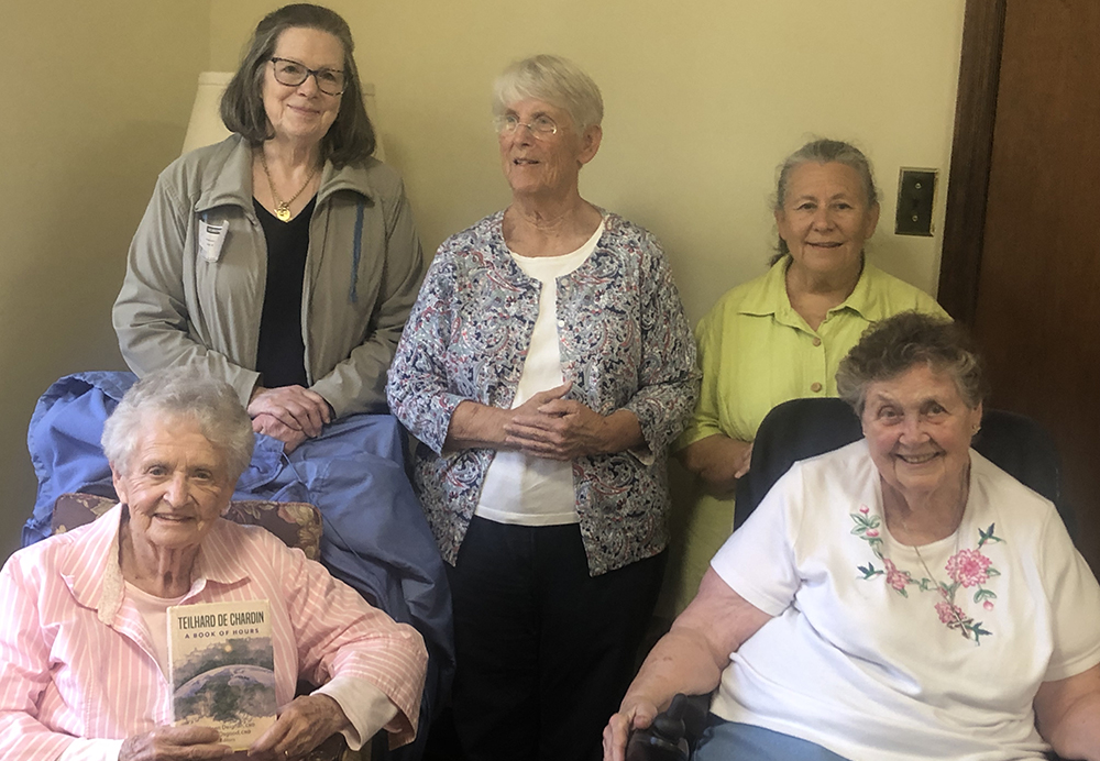 The "Elderberries" include from left (bottom row): Sr. Jeanne Clark and Sr. Mary Anna Euring, both members of the Sisters of St. Dominic of Amityville, New York.. Second row: Jacqueline Jill-Rito, Ann Michelsen and Denise Altobeli. Clark is holding a new meditation book on the teachings of Teilhard de Chardin. (Susan Perretti)