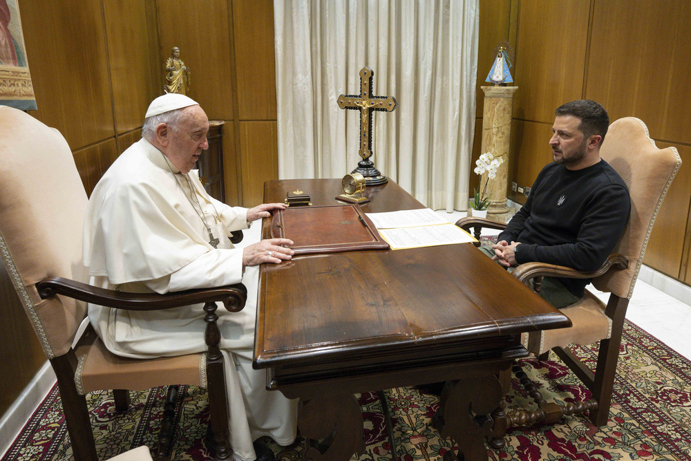 Pope Francis and President Zelenskyy sit across from each other at Pope's desk. 