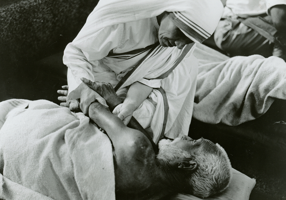 Mother Teresa of Kolkata cares for a sick man in an undated photo. (CNS/KNA)