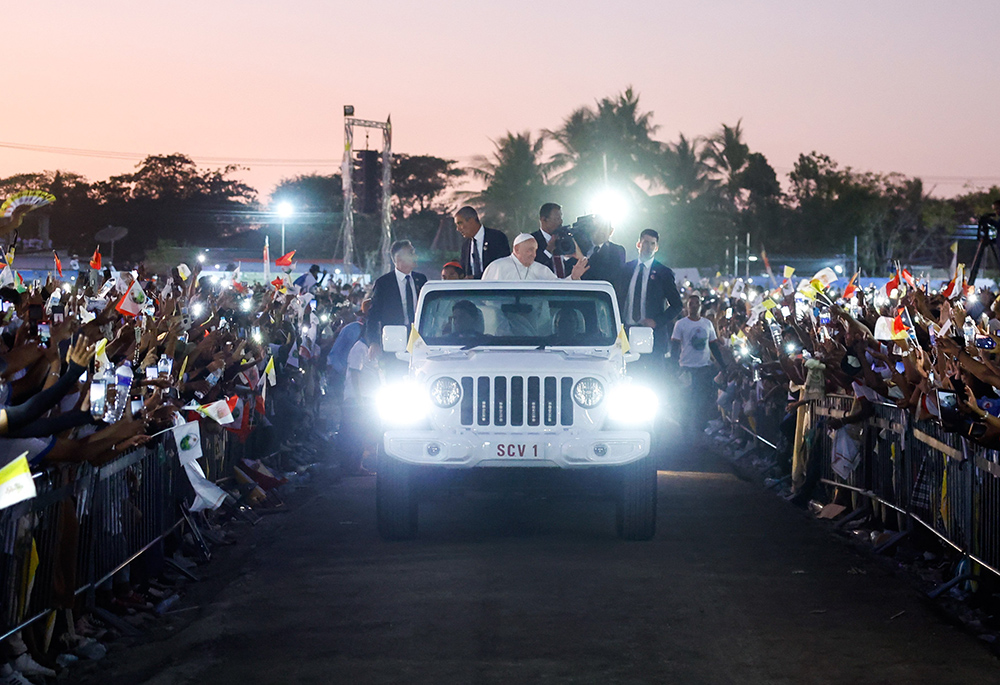 Pope Francis waves to the faithful from the popemobile as he circles the crowd following an outdoor Mass in Tasitolu, East Timor, on Sept. 10. (CNS/Lola Gomez)