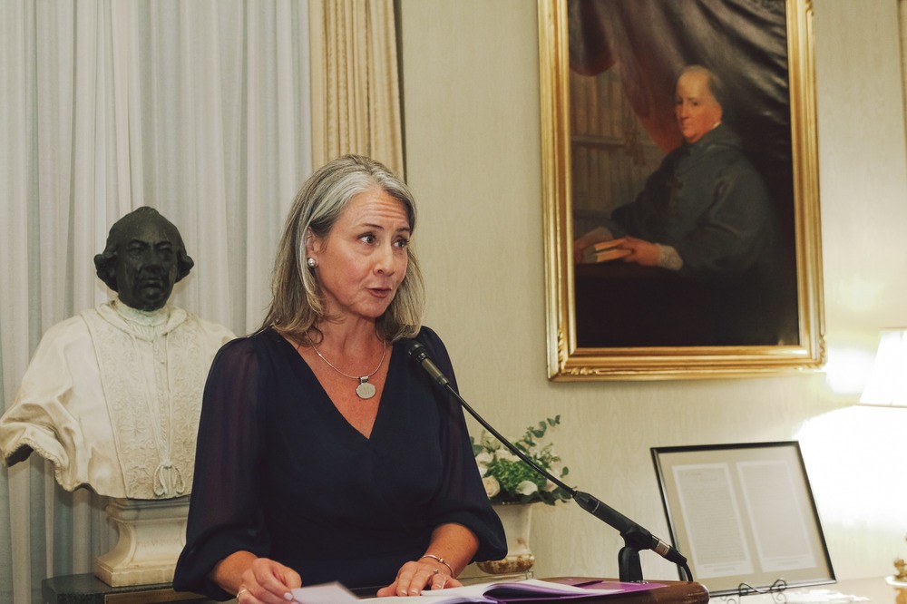 Vaillancourt Murphy stands at a podium delivering remarks. 