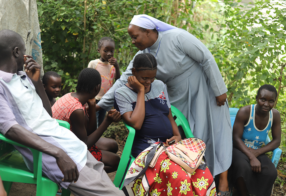 Sr. Celestine Nelima of the Sisters of Mary of Kakamega, interacts with flood victims in the Khumwanda displacement camp in Busia, a town in western Kenya, on July 17. (GSR photo/Doreen Ajiambo)