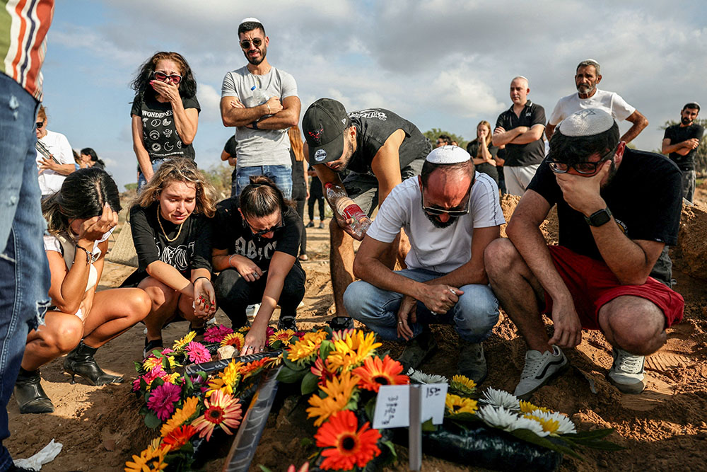 People mourn at the graveside of Eden Guez during her funeral in Ashkelon, Israel, Oct. 10, 2023. She was killed while attending a festival that was attacked by Hamas gunmen from Gaza. (OSV News/Reuters/Violeta Santos Moura)