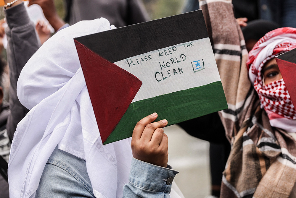 A person holds a sign during an anti-Israel demonstration, as part of a walkout by students of New York University in New York City Oct. 25, 2023. (OSV News/Reuters/Shannon Stapleton)