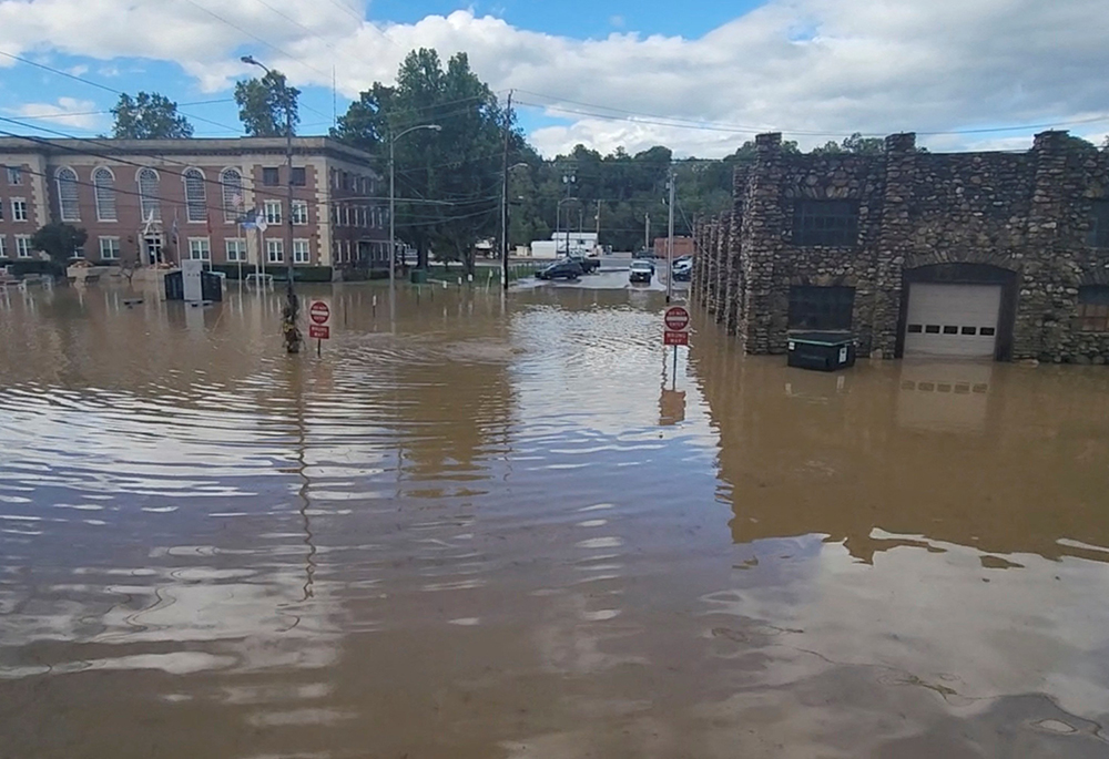 Floodwaters surround buildings Sept. 27 in Newport, Tennessee, in the aftermath of Hurricane Helene. (OSV News/Curtis Hance/H&H Vapors via Reuters)