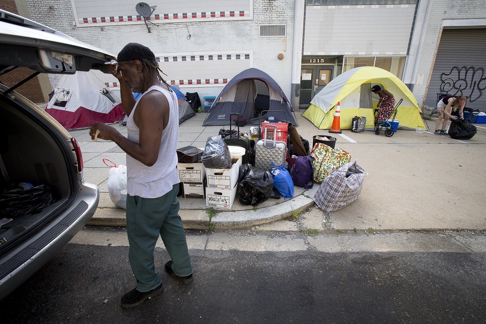 Rows of tents on sidewalk.