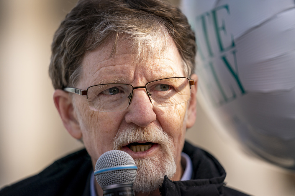 Close-up of Phillips speaking into microphone. 