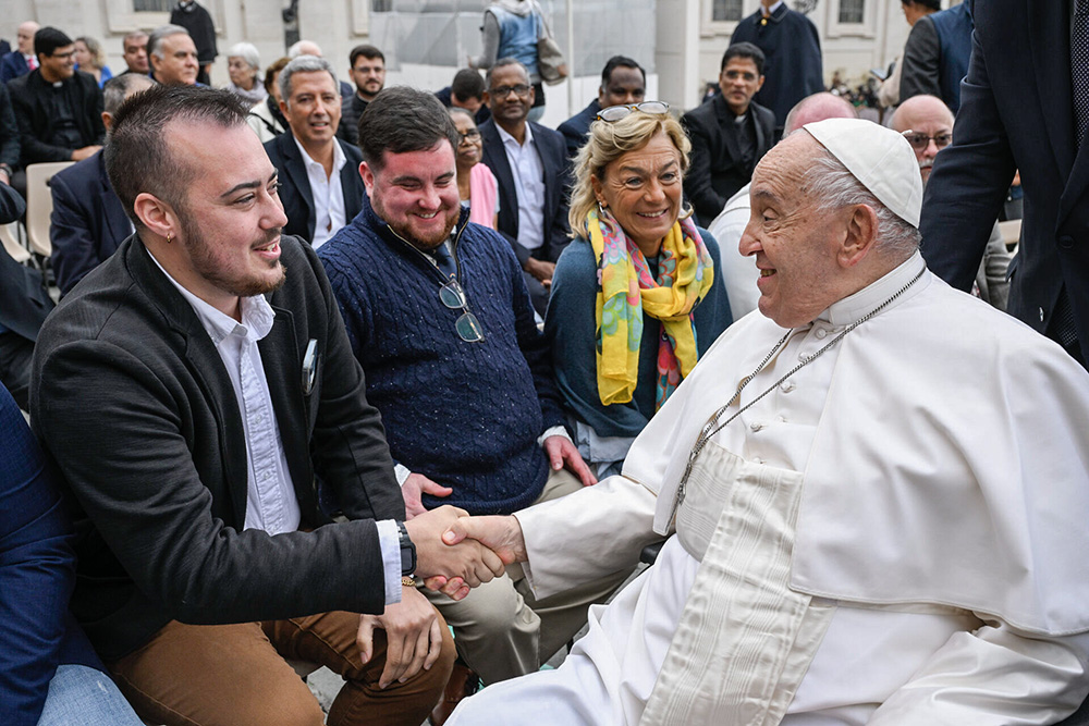 On Oct. 23, Maxwell Kuzma meets Pope Francis after a general audience as part of a group of transgender Catholic men gathered through Outreach. (Vatican Media)