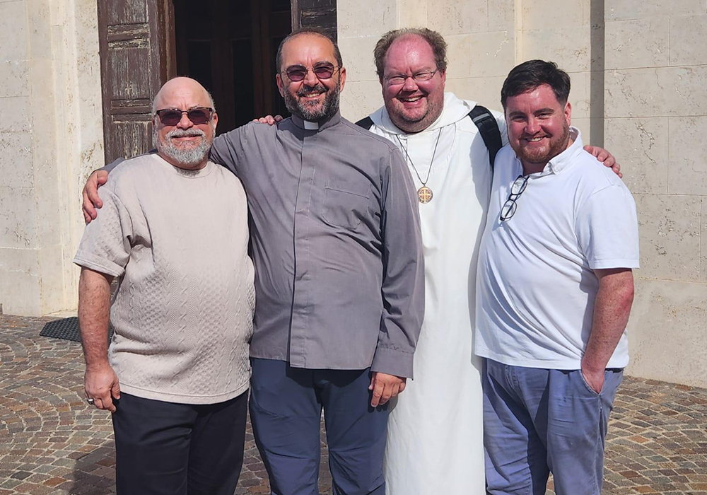 From left to right: Scotty Pignatella;* Fr. Andrea Conocchia, an Italian priest who has been regularly bringing LGBTQ Catholics to meetings with Pope Francis; Br. Christian Matson; and George White are pictured Oct. 22 in Torvaianica, Rome. (Courtesy of George White)