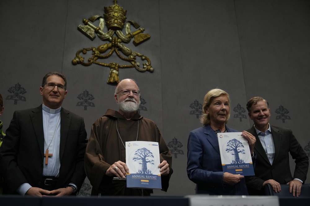 The four stand, center two hold copy of report. 