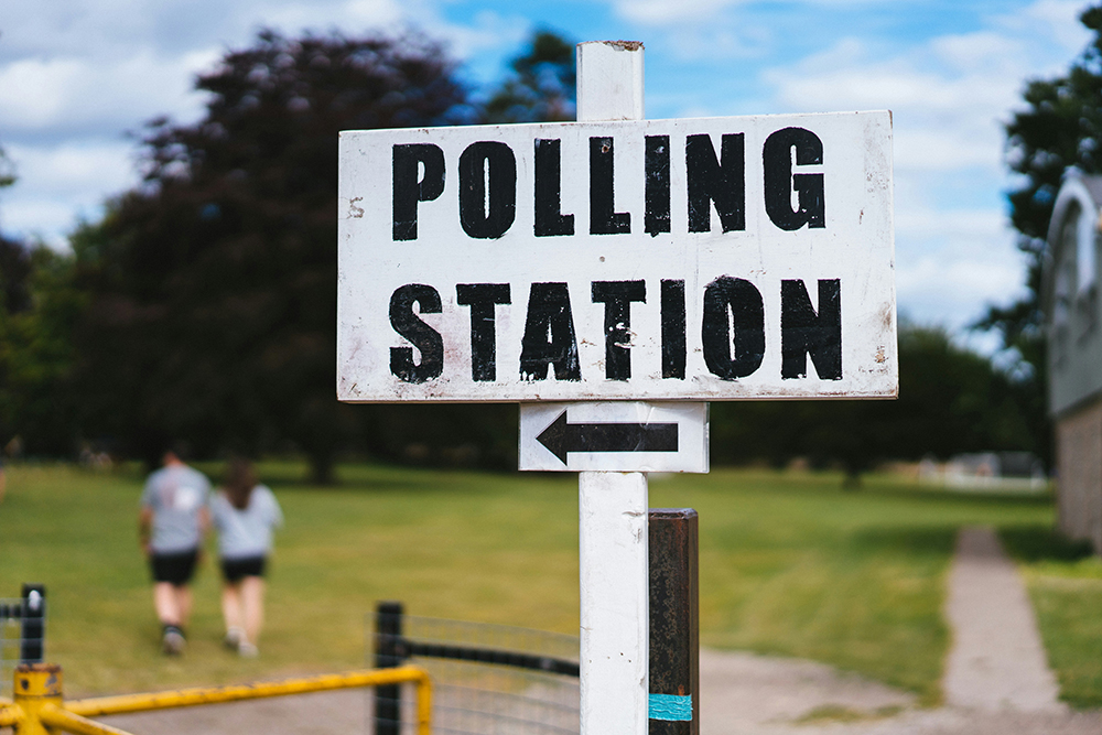 A polling station sign (Unsplash/Phil Hearing)