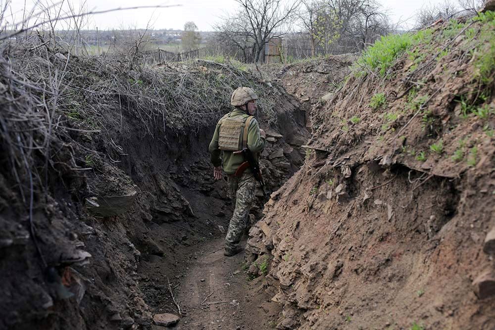 A service member of the Ukrainian armed forces walks on the line of separation near the rebel-controlled city of Donetsk April 26. 