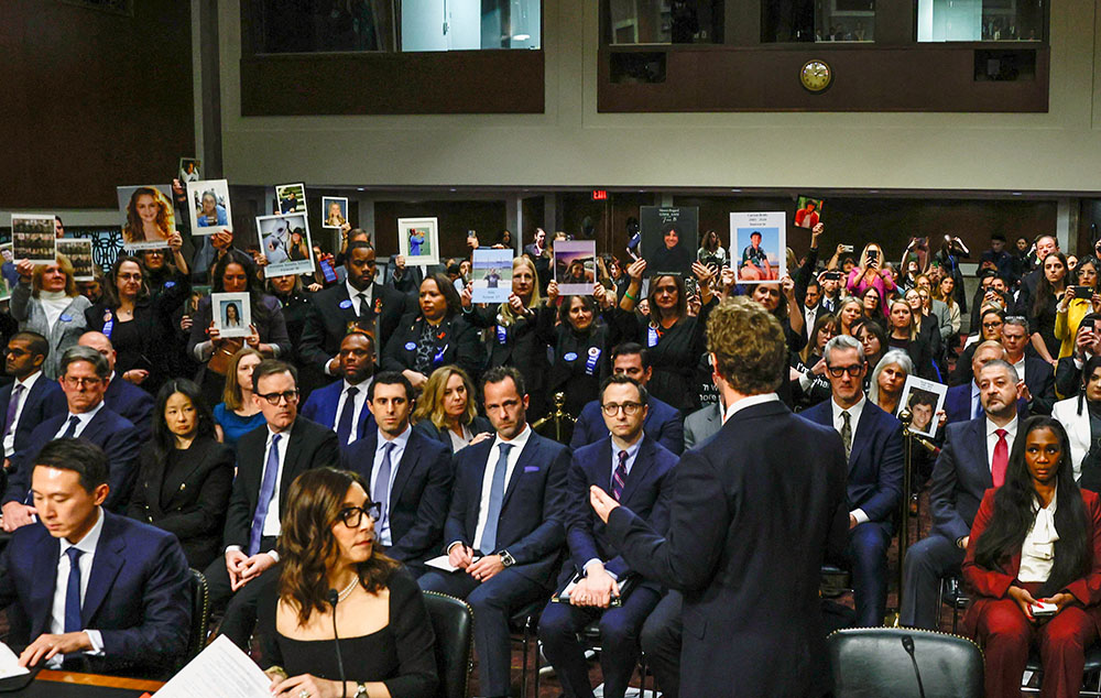 Meta's CEO Mark Zuckerberg stands and faces the audience holding up photos of their children as he testifies during the Senate Judiciary Committee hearing on online child sexual exploitation at the U.S. Capitol in Washington Jan. 31, 2024. (OSV News/Reuters/Evelyn Hockstein)