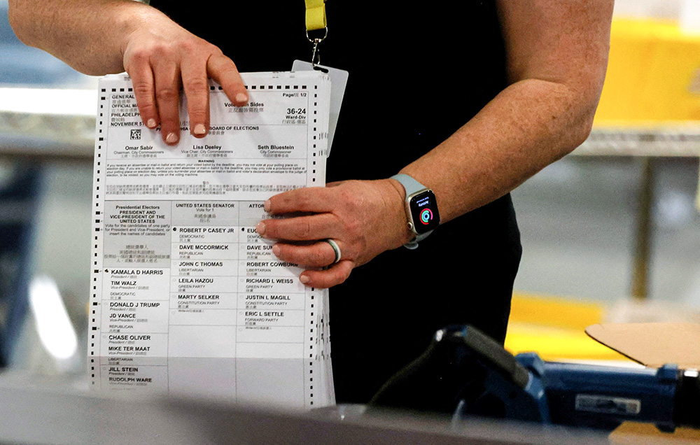 An election official scans ballots in Philadelphia during the U.S. presidential election on Election Day, Nov. 5. (OSV News/Reuters/Rachel Wisniewski)