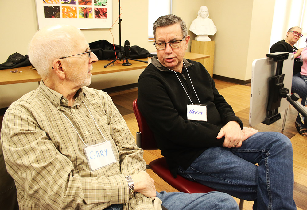 Kevin Skinner, right, talks with Spiritus community member Gary Adler before a service begins Nov. 3 in Beavercreek, Ohio. (NCR photo/Dennis Sadowski)