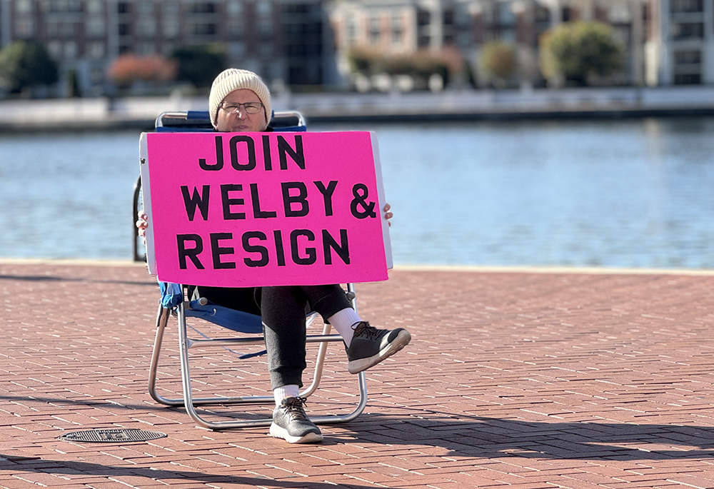 Robert Hoatson holds a sign aimed at U.S. bishops, Nov. 13 outside the Baltimore hotel where the U.S. Conference of Catholic Bishops gathered for its annual fall meeting. Hoatson was representing Road to Recovery, an organization that helps victims and survivors of clergy sex abuse. (NCR photo/Rhina Guidos) 