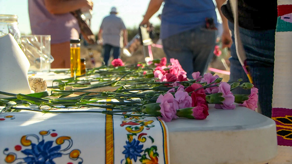 Interfaith clergy prepare an altar in the desert to honor those who have died without names or identification in the desert in Santa Teresa, New Mexico. (KTSM/Jesus Baltazar)