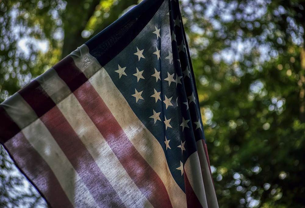 An American flag is pictured in this photo illustration. (Unsplash/Robin Jonathan Deutsch)