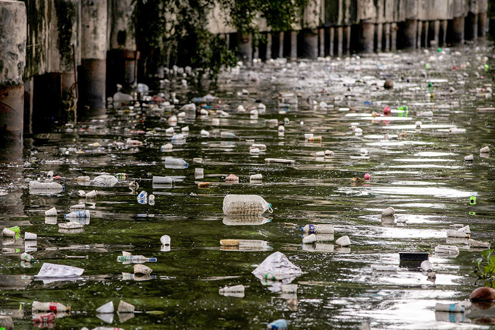 Plastic bottles float on the heavily polluted San Juan River, a tributary of Pasig River in Mandaluyong City, Philippines, June 21, 2021. (OSV News/Reuters/Eloisa Lopez)