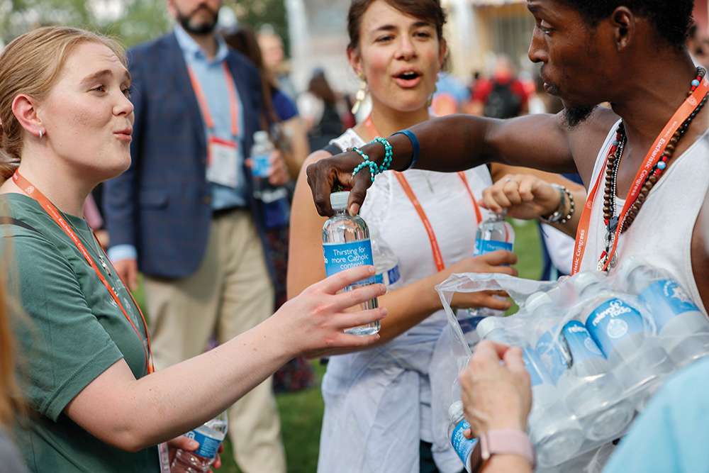 Pilgrims receive bottled water during the National Eucharistic Congress procession in Indianapolis July 20. (OSV News/Rhode Island Catholic/Rick Snizek)