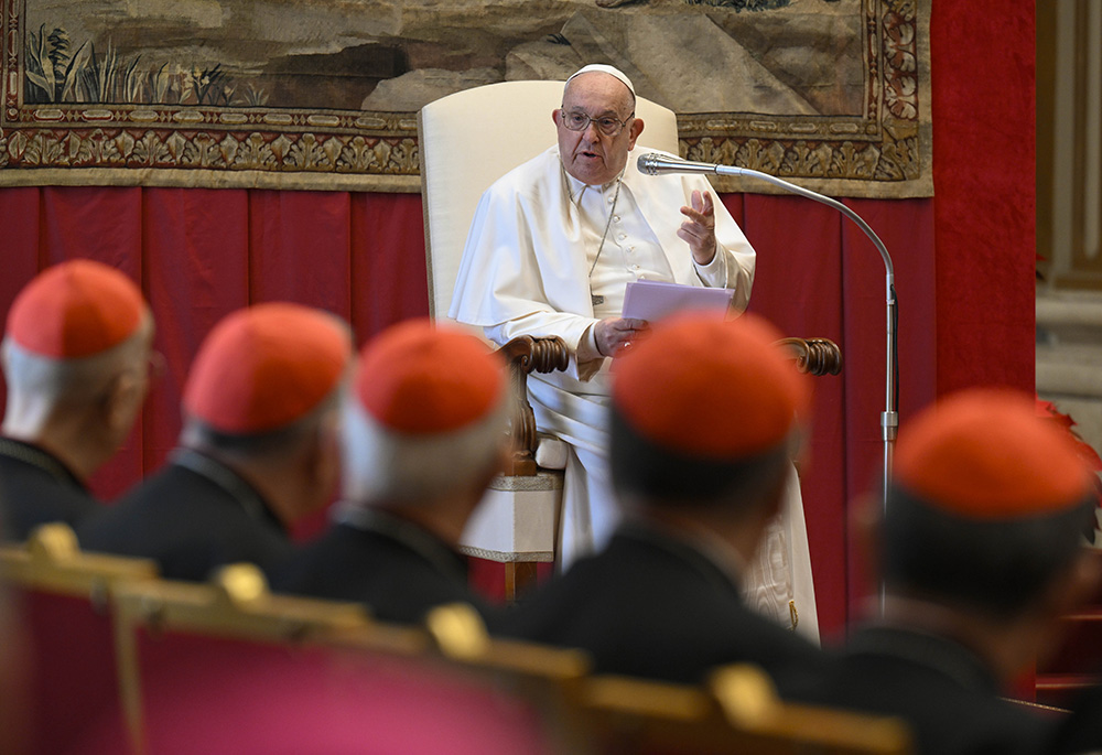 Pope Francis reads his speech to officials of the Roman Curia and the College of Cardinals during his annual pre-Christmas meeting with them in the Hall of Blessing above the atrium of St. Peter's Basilica at the Vatican on Dec. 21. (CNS/Vatican Media)