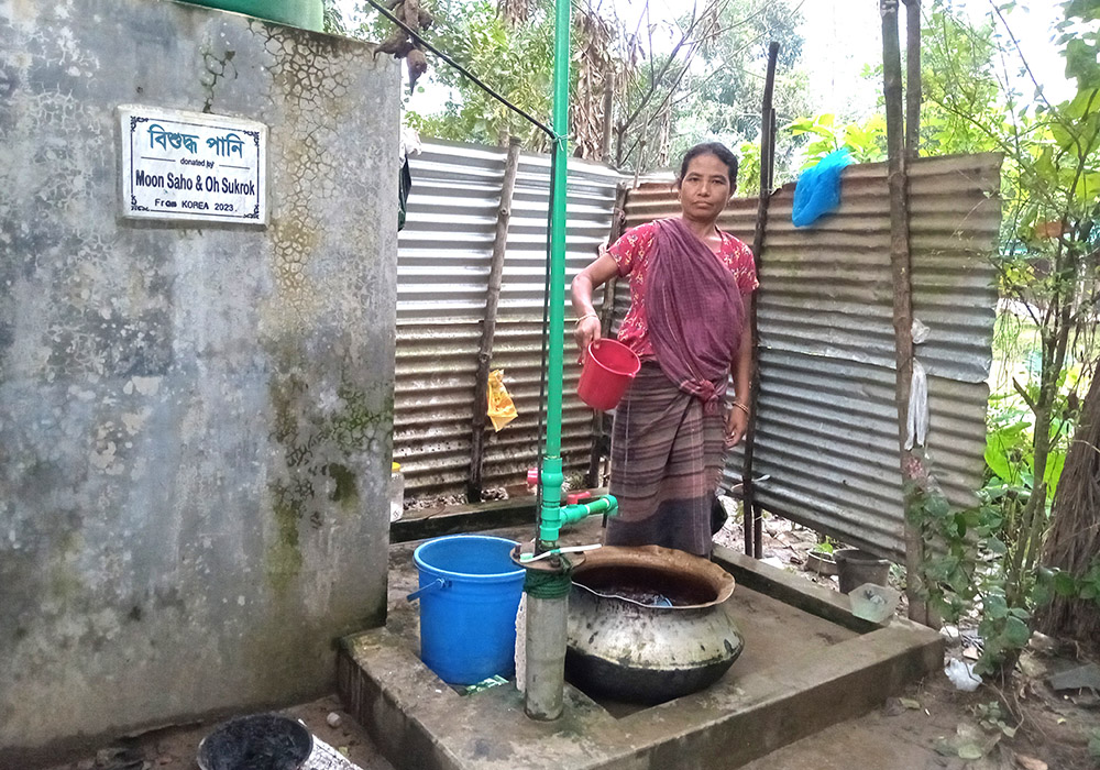 Shima Dafo, 45, a Garo Catholic woman from the Baromari Parish, uses a tube well to meet the clean water needs of her family of 10. (Sumon Corraya)