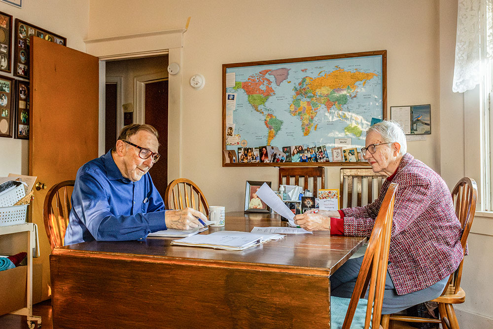 Mel and Mary Ann Beckman work on the Nebraska Criminal Justice Review at their dining room table on Nov. 19, 2024, in Omaha, Nebraska. Mel, who founded the review, handed over editing duties to Jeanie Mezger in 2023. (Flatwater Free Press/Joseph Saaid)