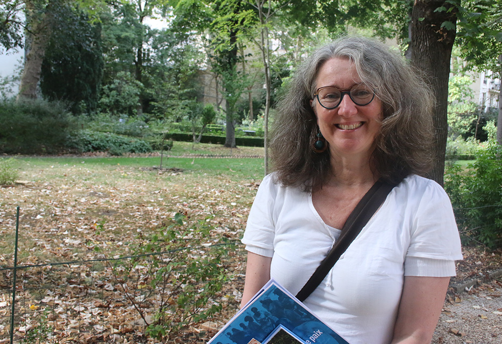 Cécile Dubernet, senior lecturer and director of the civil peace intervention program at the Catholic University of Paris, is seen in a garden on campus. (Dennis Sadowski)